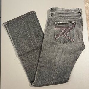 7 For All Mankind grey bootcut jeans with pink pocket stitching.